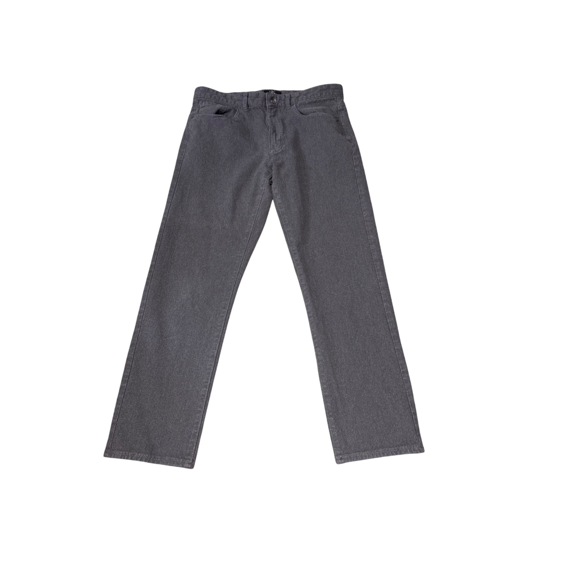 A pair of dark gray slim-fit jeans laid flat against a solid white background.