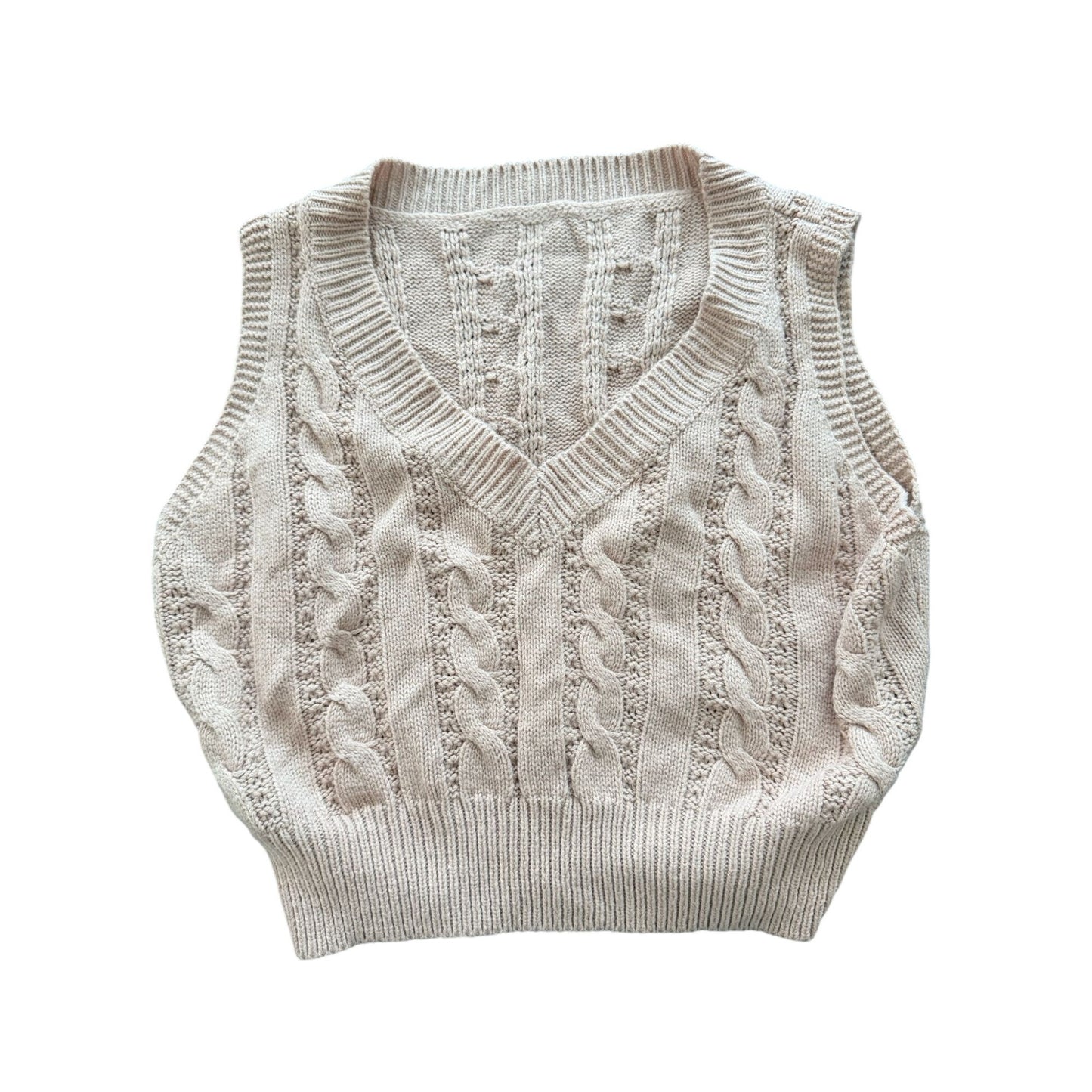 A cream-colored cable-knit sweater vest with a V-neck, laid flat against a solid white background.
