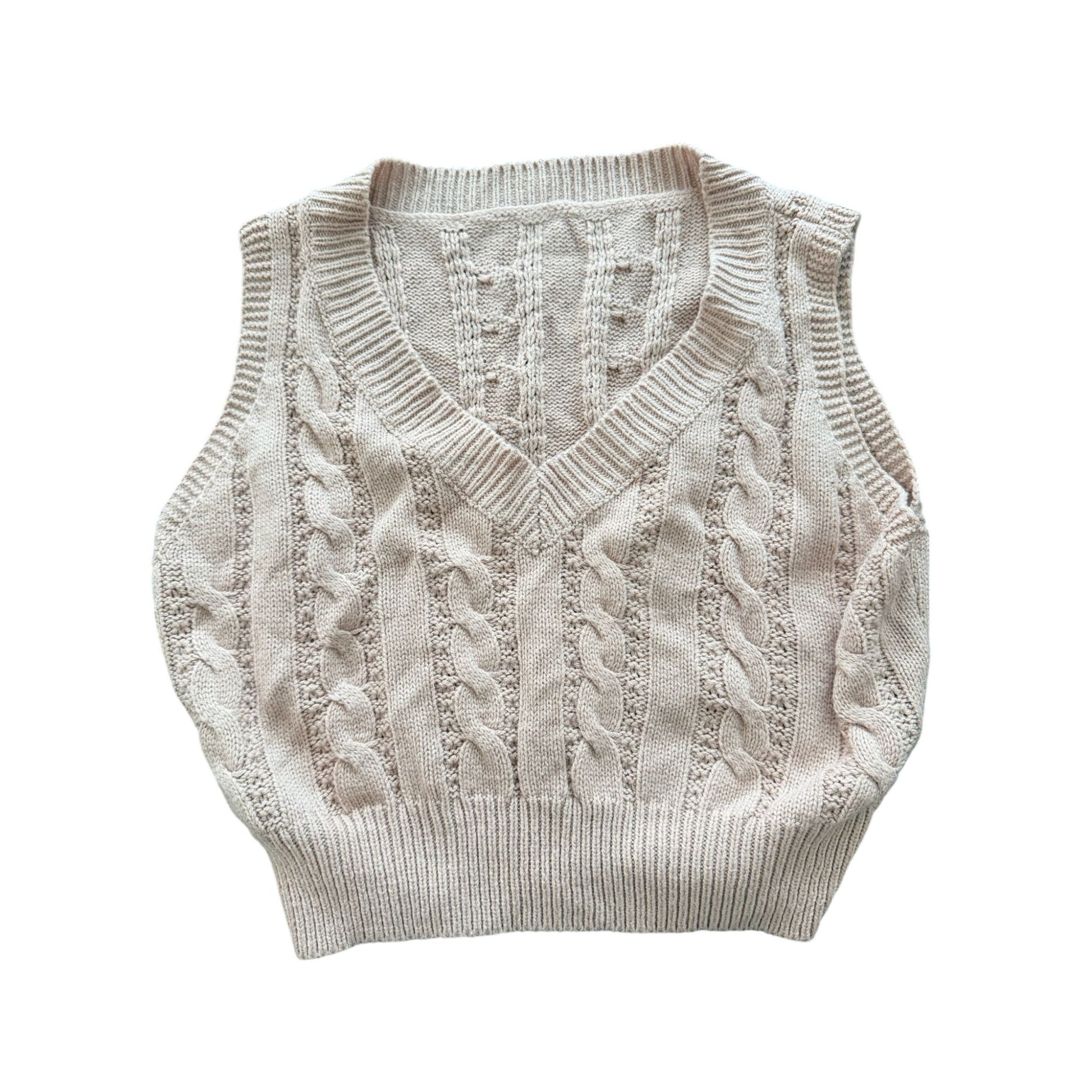 A cream-colored cable-knit sweater vest with a V-neck, laid flat against a solid white background.