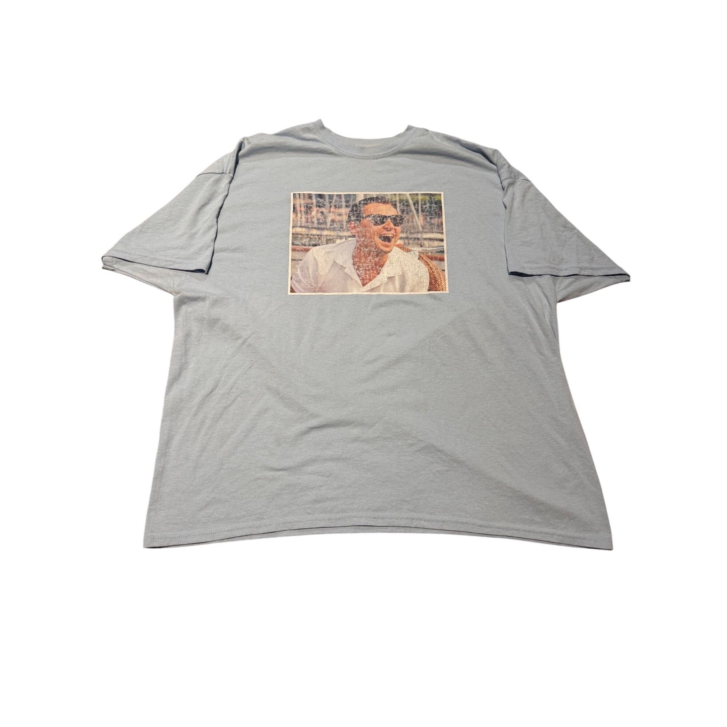 A light gray short-sleeve t-shirt with a rectangular graphic print on the chest showing a vintage-style portrait of a man in sunglasses.