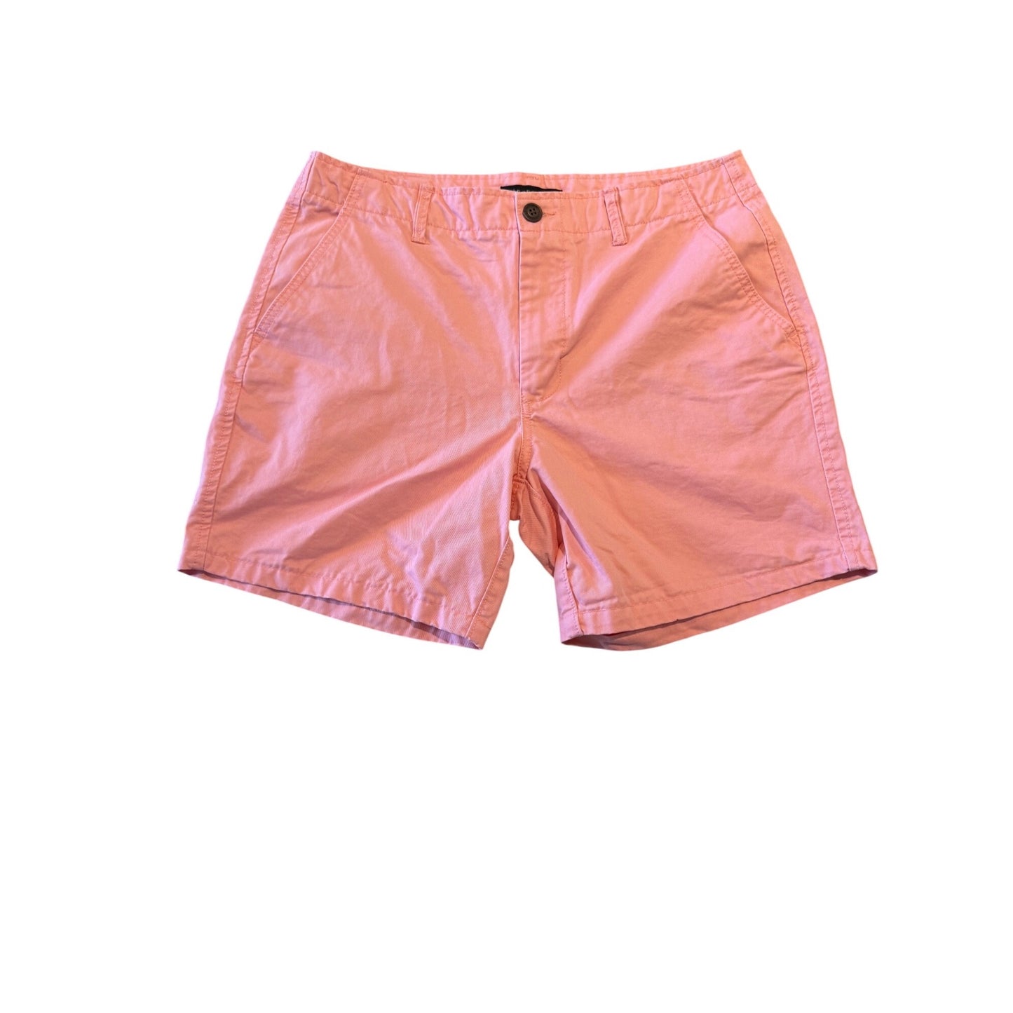 A pair of coral pink cotton shorts with a button closure and belt loops, laid flat against a white background.