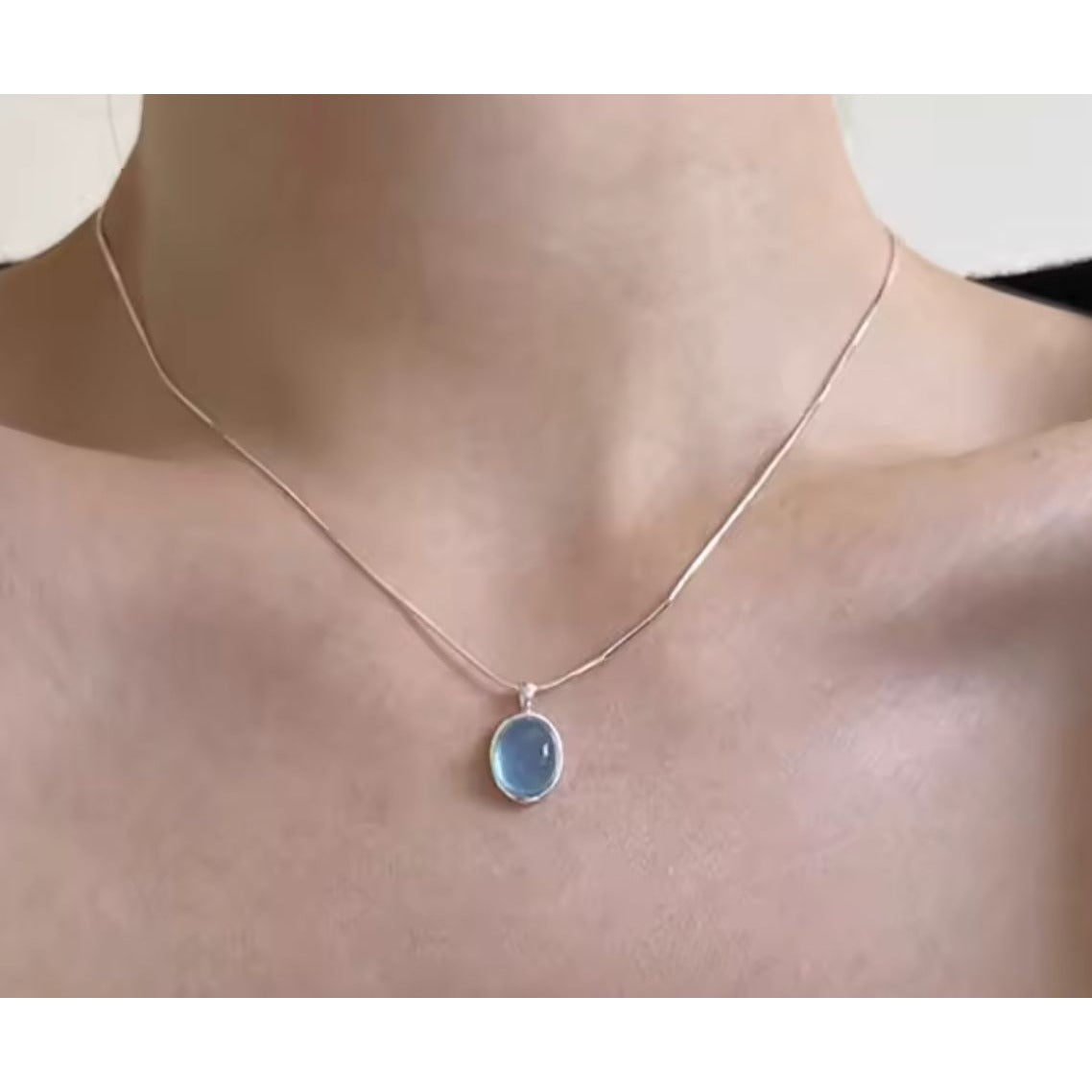 Necklace with a blue pendant on a mannequin