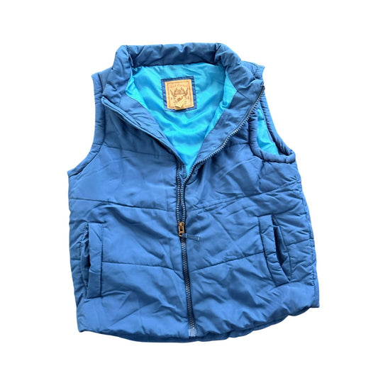 A blue quilted puffer vest with a high collar, front zipper, and side pockets, shown flat against a white background. The interior lining is a bright turquoise blue, and a small tan brand patch is visible inside the collar.