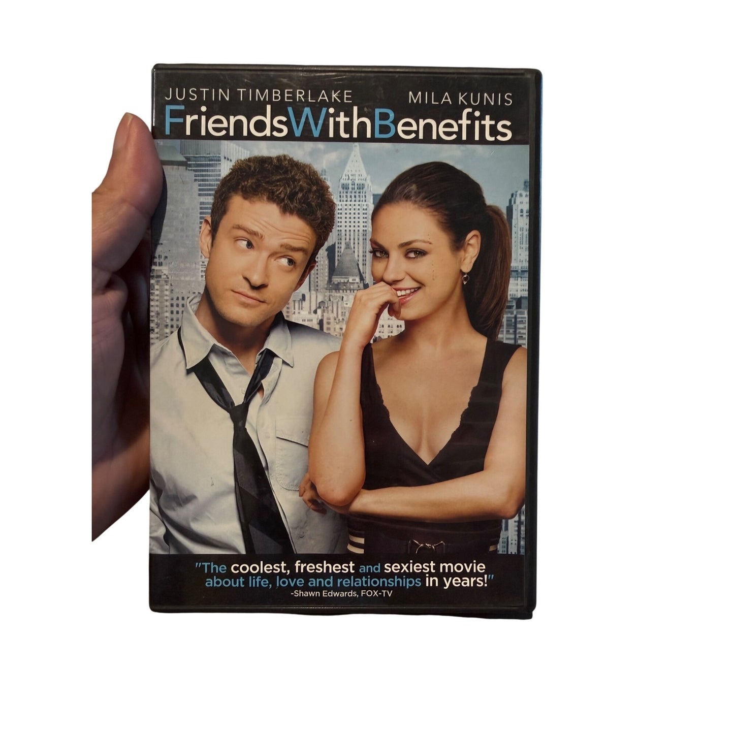 A hand holding a DVD case for the movie 'Friends With Benefits' against a plain white background.