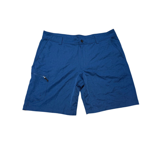 A pair of royal blue athletic shorts with a zippered cargo pocket on the left leg, laid flat against a solid white background.