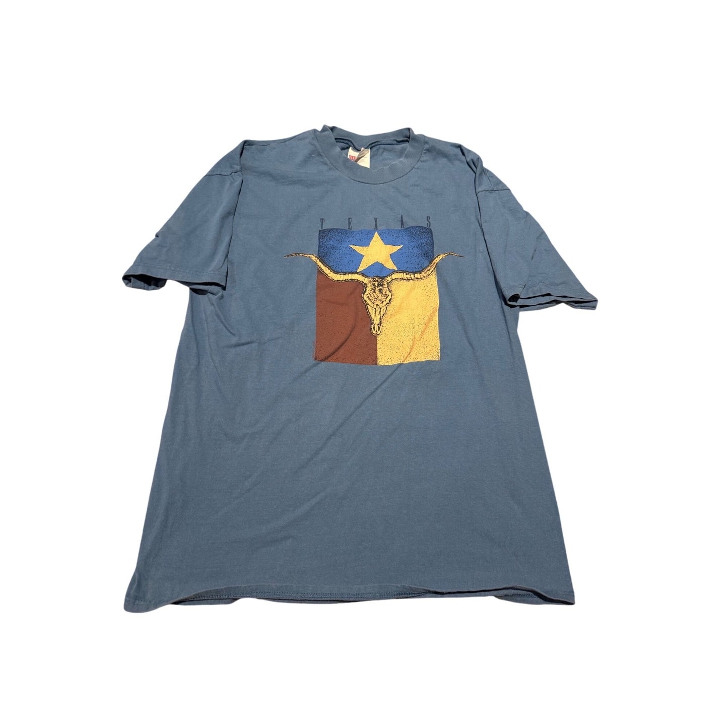 A faded blue short-sleeve t-shirt with a distressed graphic of a longhorn steer skull in front of a split blue and brown flag with a yellow star, displayed flat against a white background.