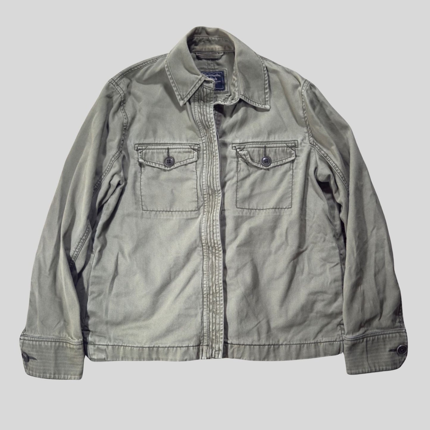 Gray jacket with two front pockets on a light gray background