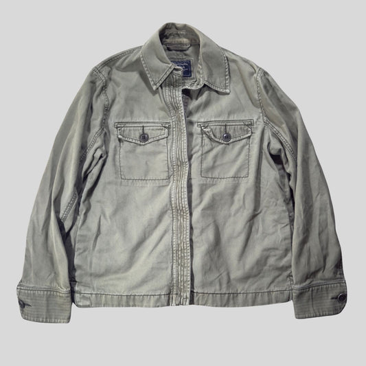 Gray jacket with two front pockets on a light gray background